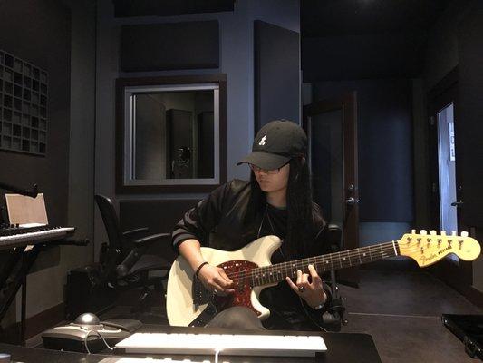 Crē*8 Music Academy Student-Producer cutting electric guitar in Studio A.