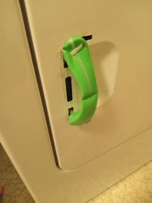 Dryer handle replaced with green vinyl and zip ties