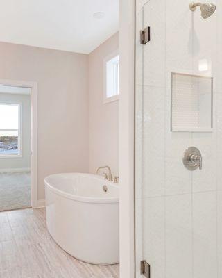 Custom freestanding tub and fully tiled shower