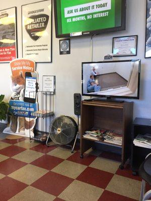 Comfortable waiting area with free WiFi, soda machine, and snack machine.