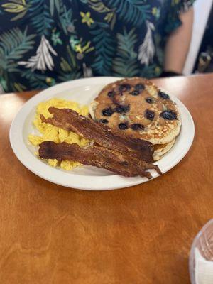 Eggs bacon and blueberry pancakes