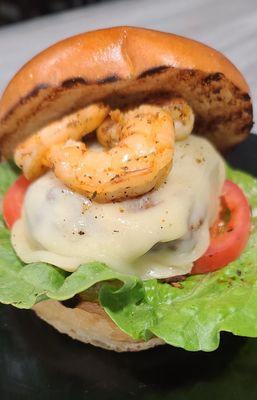 The unkommon lamb burger with grilled shrimp and smoked provolone