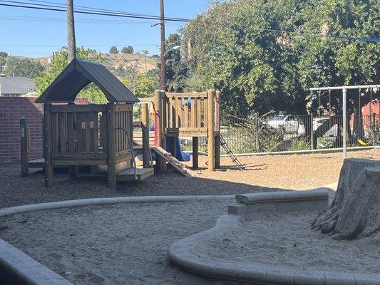 We have a beautiful wooden structure and sand area.