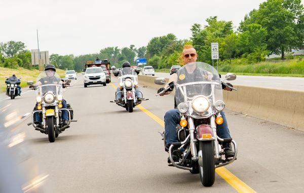 The Biker Lawyers riding motorcycles down a highway