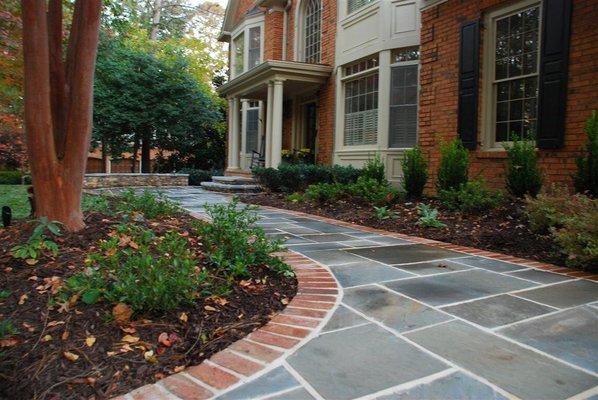 Bluestone walkway with brick border, fresh curb appeal in Country Club of the South, Roswell, GA by The Inspired Garden.