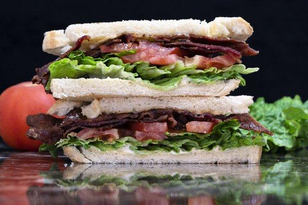 BLT - (Most Popular) crisp leaf lettuce, 3 slices of tomato sprinkled with salt and pepper, bacon and mayo between toasted bread.