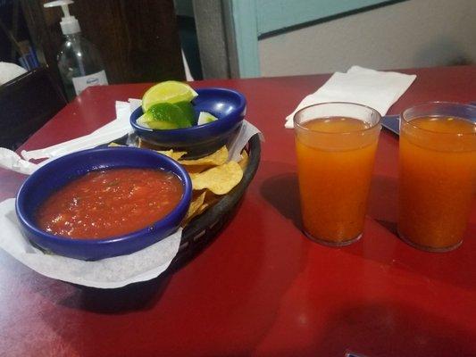 Chips and salsa,  and cups of soup broth.