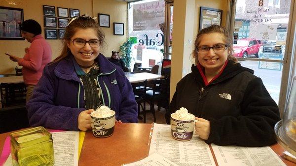 The twins staying warm with hot chocolates made by Maria