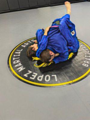 Father and son "rolling" during Brazilian Jui jitsu