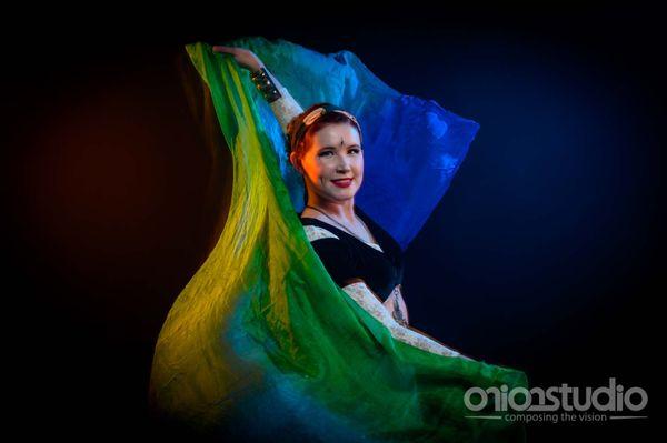 Liz of Emerald Starling Belly Dance dancing with a silk veil.