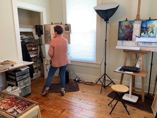 Artist Anne Milligan at the easel in the gallery's studio