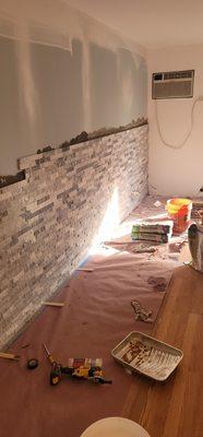 Progress on Alaskan Gray Marble stone tile wall.