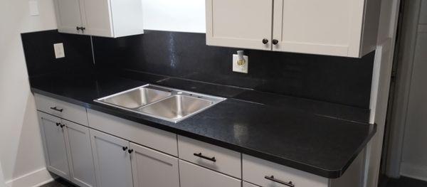 New laminate countertops with full height laminate backsplash in a remodel