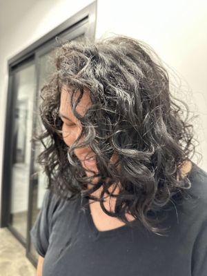 Medium length curly cut on wavy hair