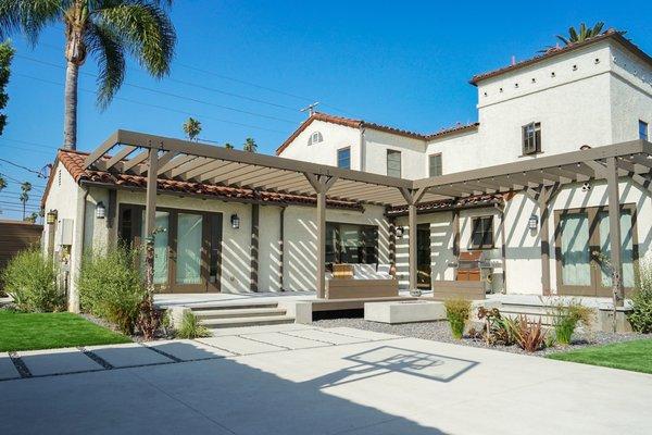 Pergola, built in benches, sand finish concrete firepit and pavers, artificial turf, outdoor shower, fencing, drought tolerant plantings.