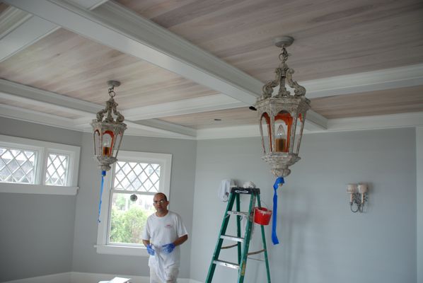 A house on the water. We pickled the ceiling and did the whole room. Awesome antique lamps hanging.