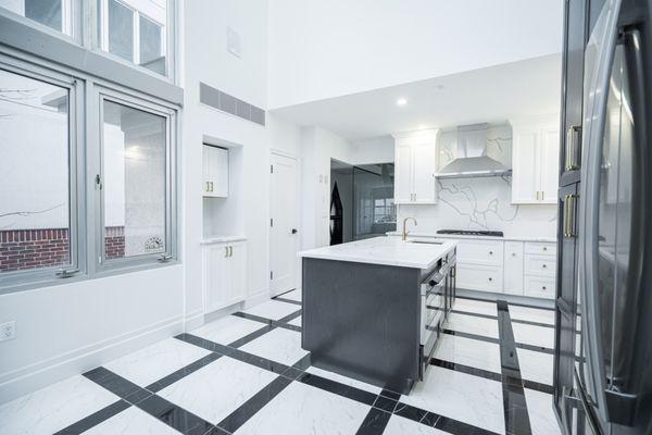 Grey kitchen island with white veined countertop