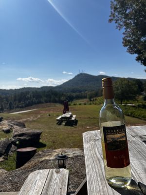 A bottle of the Ms. Lilly with Currahee mountain in the background