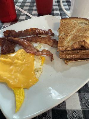 Hard egg with American cheese, bacon, and rye toast.