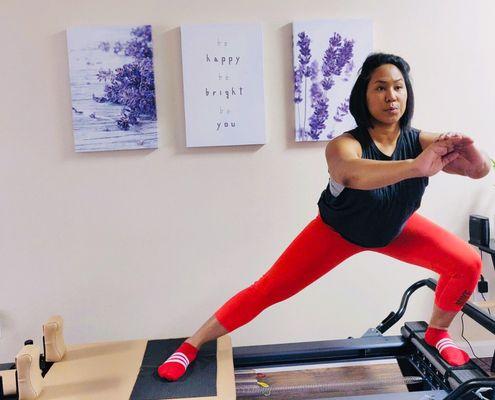 Pilates side lunges on the reformer