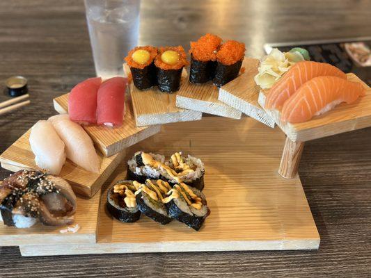 left to right in this photo : eel nigiri, hamachi nigiri, maguro nigiri, tobitama, tobiko, sake nigiri, and ninja roll no cream cheese.