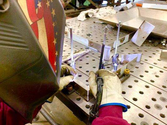 One of our welders tig welding on the jig table.