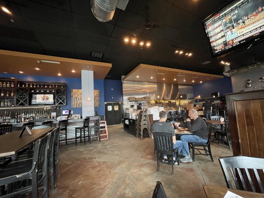 Wide angle view showing part of the bar (left) and part of the kitchen (right).