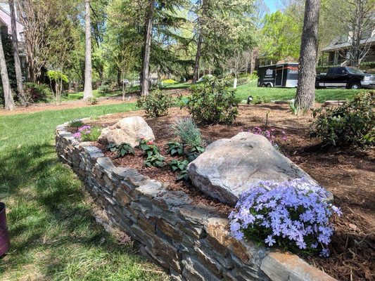 The boulders are going to accent the annual bed and the creeping Phlox will spill over the wall!