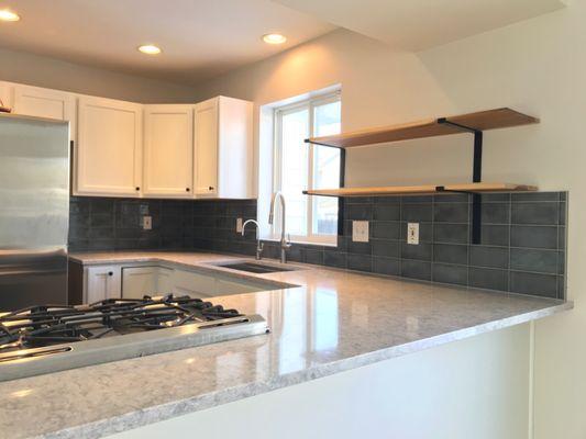 Custom tile backsplash with metal trim.