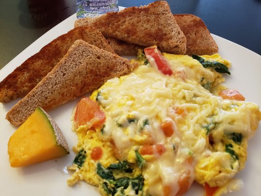 Spinach tomato scramble with an extra egg and housemade toast