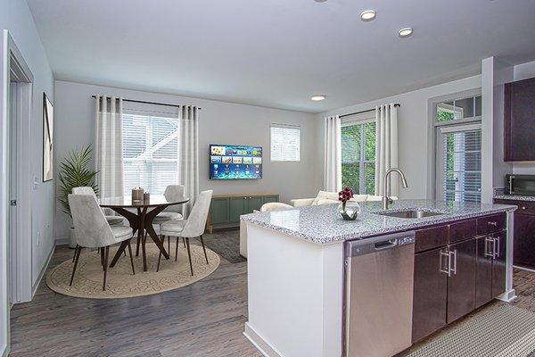 Upgrades include designer lighting and new luxury vinyl plank flooring in baths, living, and dining areas