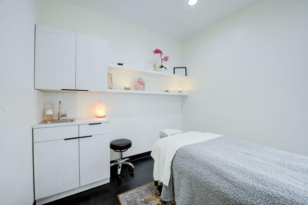 Warm salt lamps and aromatherapy candles surround your massage space