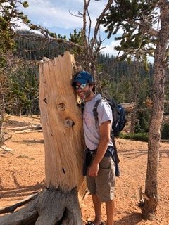 Prep U founder and chief tutoring officer David Storper hugs a tree in the mountains of Utah.