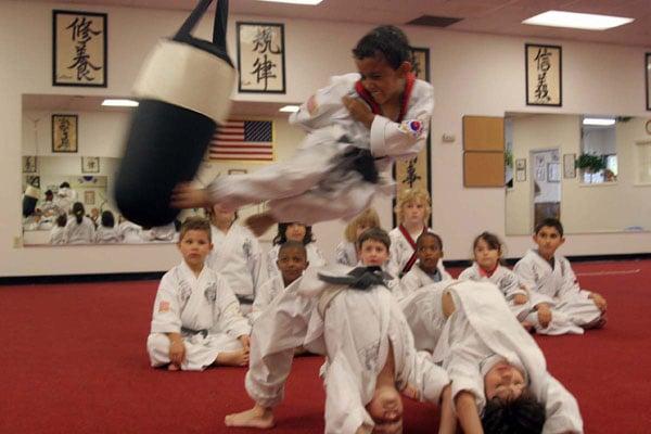 Kids practicing jump kicking