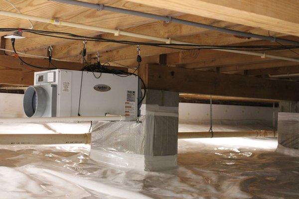 Crawlspace encapsulation, moisture barrier installation, dehumidifier installation and duct work by Economy Exterminators