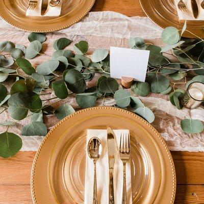 Elegant table setting and greenery for centerpieces