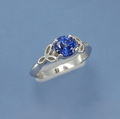 A unique custom bridal ring featuring a blue sapphire.