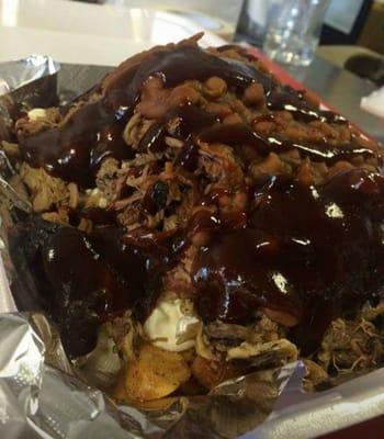 This is called the "PIG PEN" Loaded w/steak fries Mac salad, Pulled pork Smokey baked beans and slathered in bbq sauce!