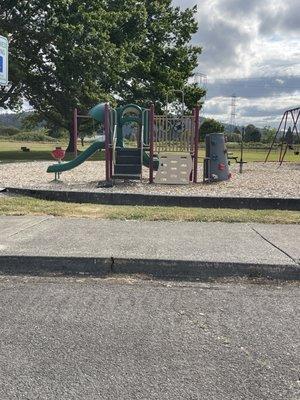 Toddler play structure between softball fields