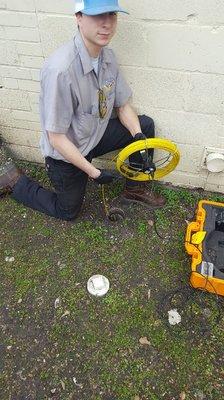 Inspecting a sewer line with camera.