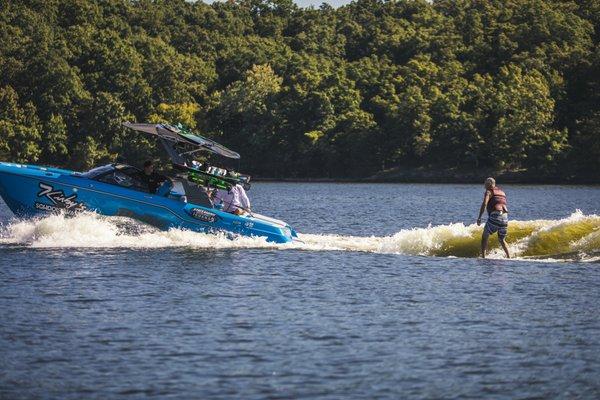 Wakesurfing lesson behind a Malibu wakeboat