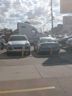 My car parked at the front of the very crowded shop