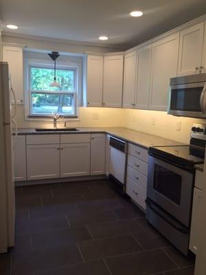 Kitchen remodel with LED under cabinet & recessed lighting. Porcelain floor, subway tile backsplash & granite counters