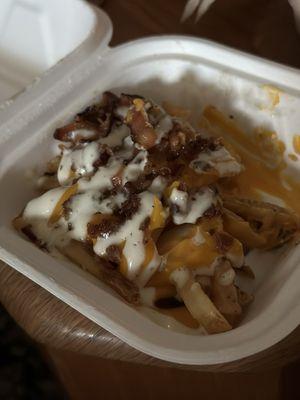 Undercooked fries with bacon, cheese, and ranch