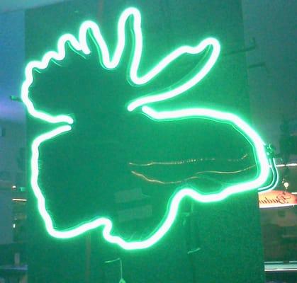 Neon sign in the shape of a moose head inside the back room.