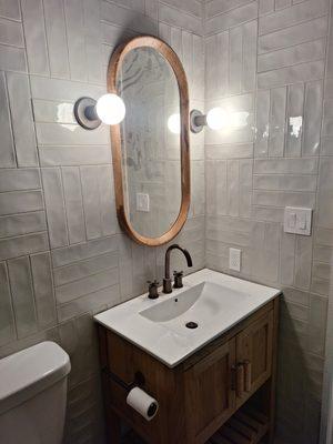 install sink, plumbing, lights, and mirror