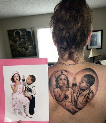 Portrait tattoo of my kids with an added nursing/healthcare theme on my mid upper back.