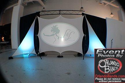 Spandex screens and scenic up lighting, with pipe and drape for your event!