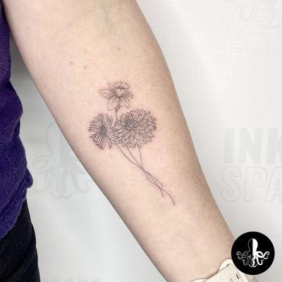 birth flowers fine line tattoo