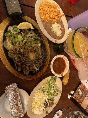 Steak fajitas with rice and beans, drinking a small frozen mango margarita